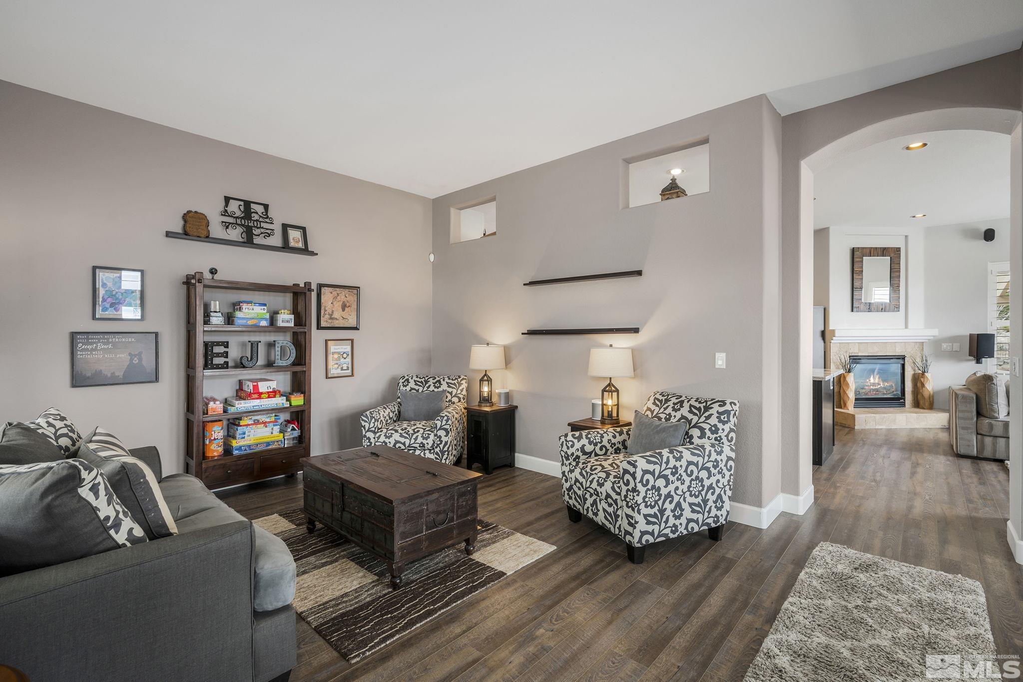 5630 North White Sands Road Reno, NV 89511 - Photo 3 of 40 a living room with furniture and a wooden floor
