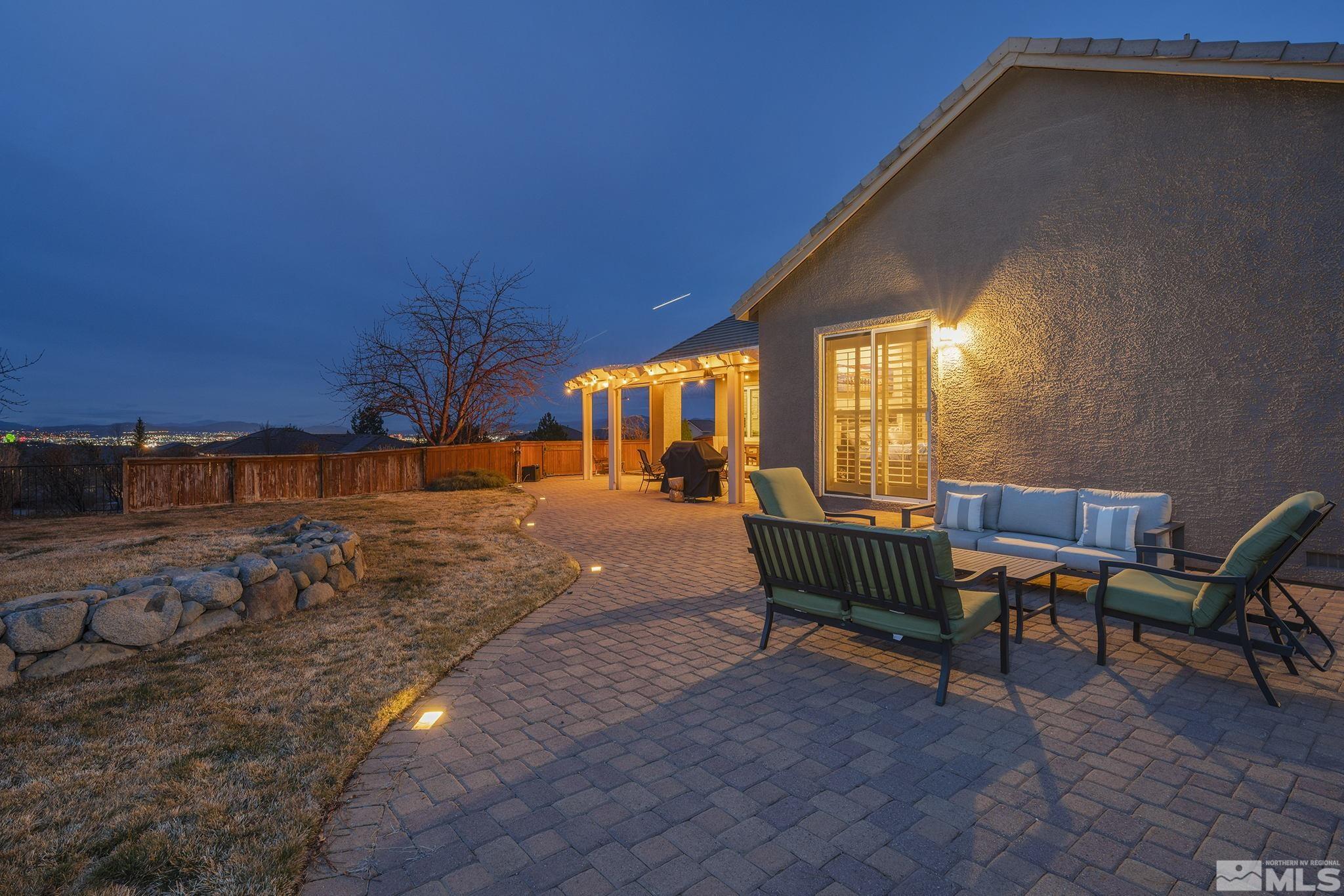 5630 North White Sands Road Reno, NV 89511 - Photo 31 of 40 a backyard of a house with table and chairs