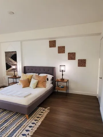 a bedroom with a bed and a table