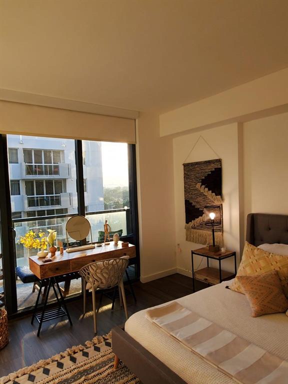 201 Southwest 17th Road, Unit 704 Miami, FL 33129 - Photo 32 of 60 a bedroom with a bed table and a window