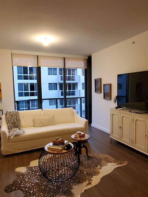 201 Southwest 17th Road, Unit 704 Miami, FL 33129 - Photo 4 of 60 a living room with furniture and a flat screen tv