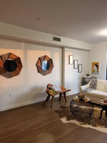 a living room with furniture and a book shelf