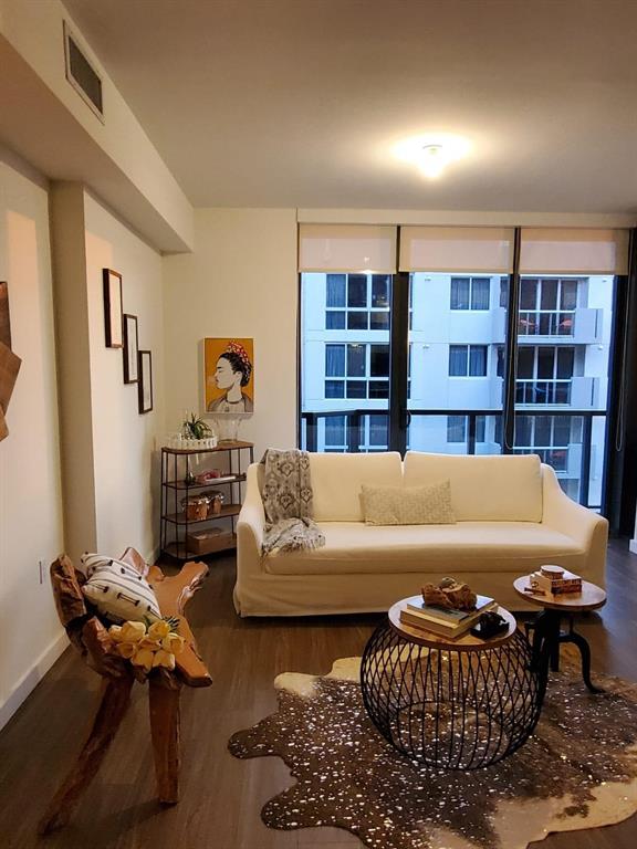 201 Southwest 17th Road, Unit 704 Miami, FL 33129 - Photo 9 of 60 a living room with furniture and a book shelf