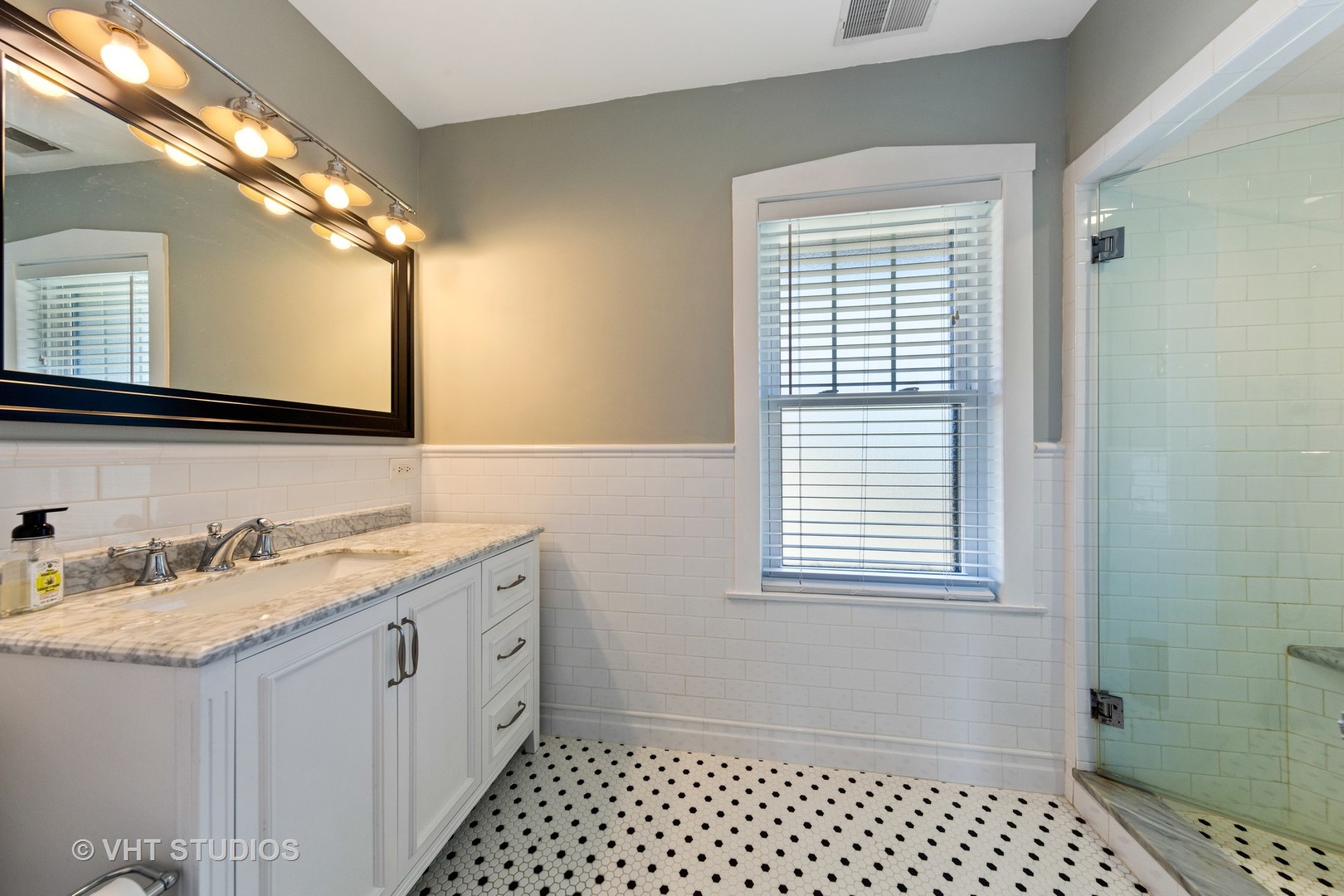 4547 Wolf Road Western Springs, IL 60558 - Photo 14 of 29 a bathroom with a granite countertop sink toilet a mirror and shower