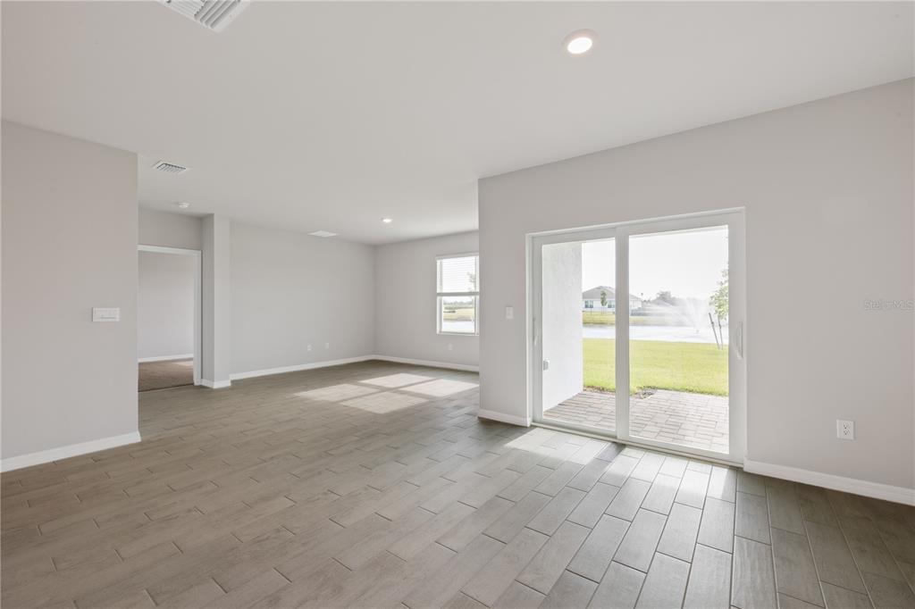 9498 Turtle Grass Circle Punta Gorda, FL 33950 - Photo 11 of 21 a view of an empty room with a fireplace and a large window
