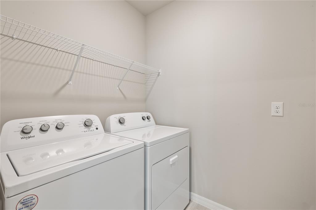 9498 Turtle Grass Circle Punta Gorda, FL 33950 - Photo 16 of 21 a utility room with dryer and washer
