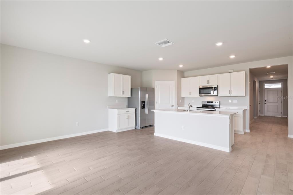 9498 Turtle Grass Circle Punta Gorda, FL 33950 - Photo 4 of 21 a view of kitchen with white cabinets