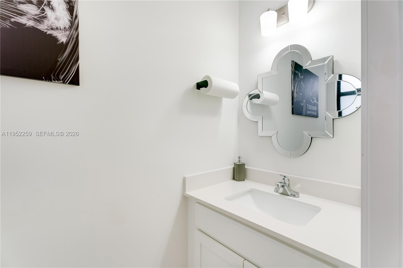 19410 Southwest 124th Court Miami, FL 33177 - Photo 12 of 33 a bathroom with a sink and mirror
