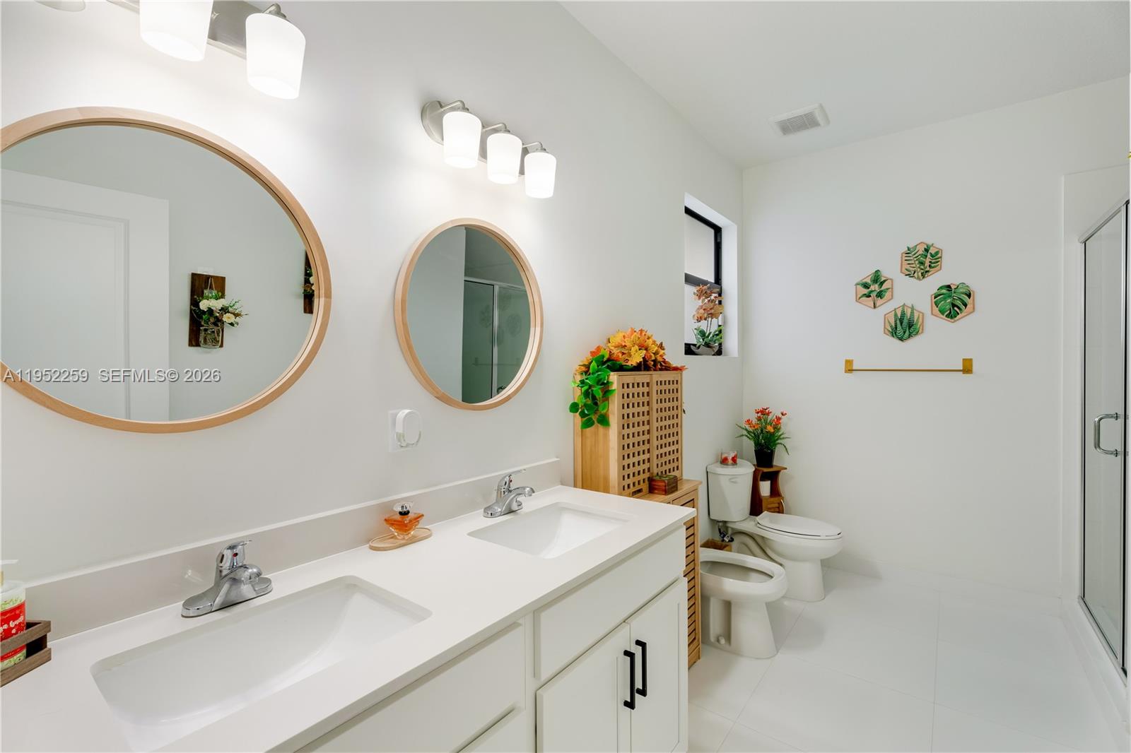 19410 Southwest 124th Court Miami, FL 33177 - Photo 19 of 33 a bathroom with a toilet a sink and a mirror