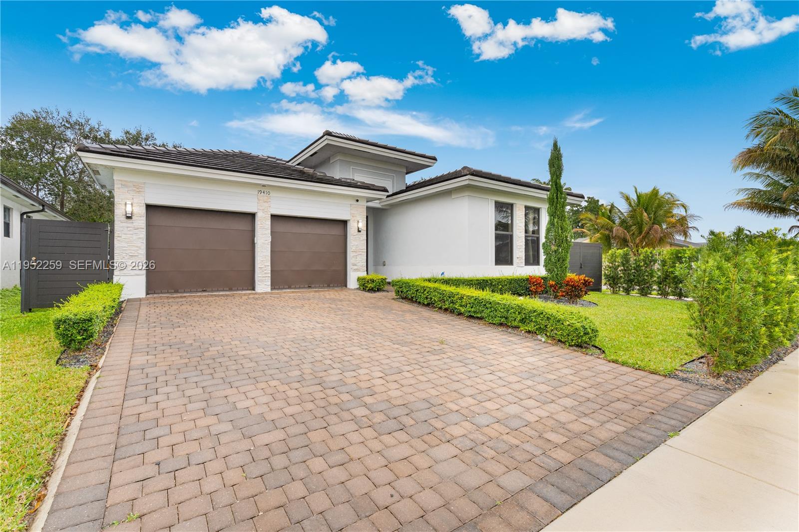 19410 Southwest 124th Court Miami, FL 33177 - Photo 2 of 33 a front view of a house with a yard and a garage