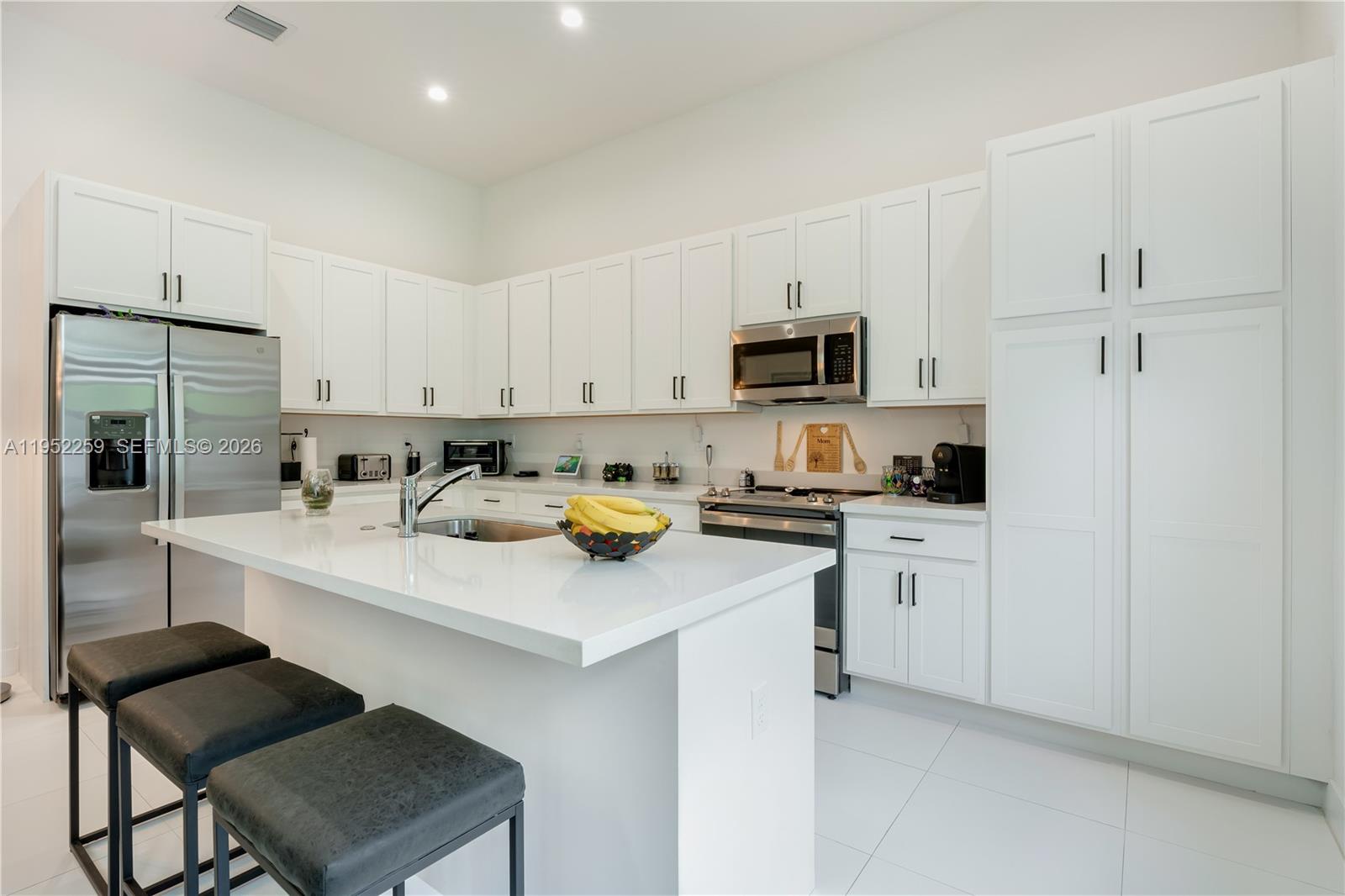 19410 Southwest 124th Court Miami, FL 33177 - Photo 9 of 33 a kitchen with sink cabinets and appliances