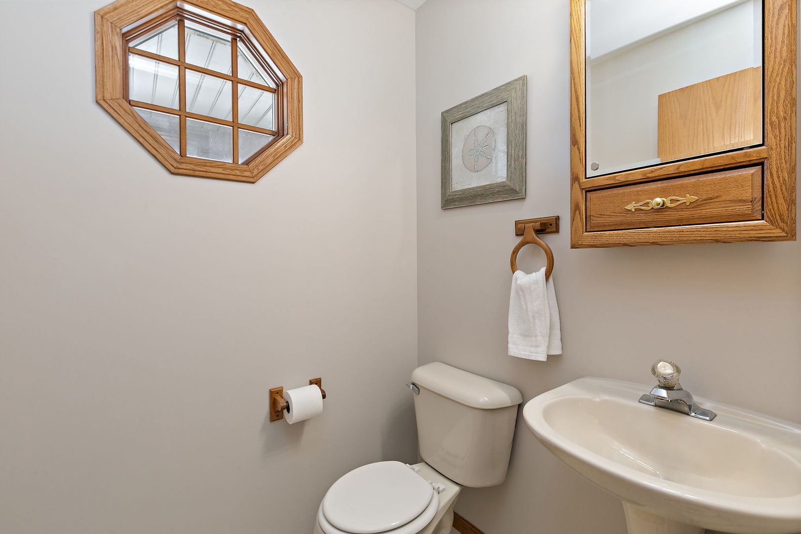 1205 South 1st Street DeKalb, IL 60115 - Photo 15 of 43 a bathroom with a toilet sink and mirror