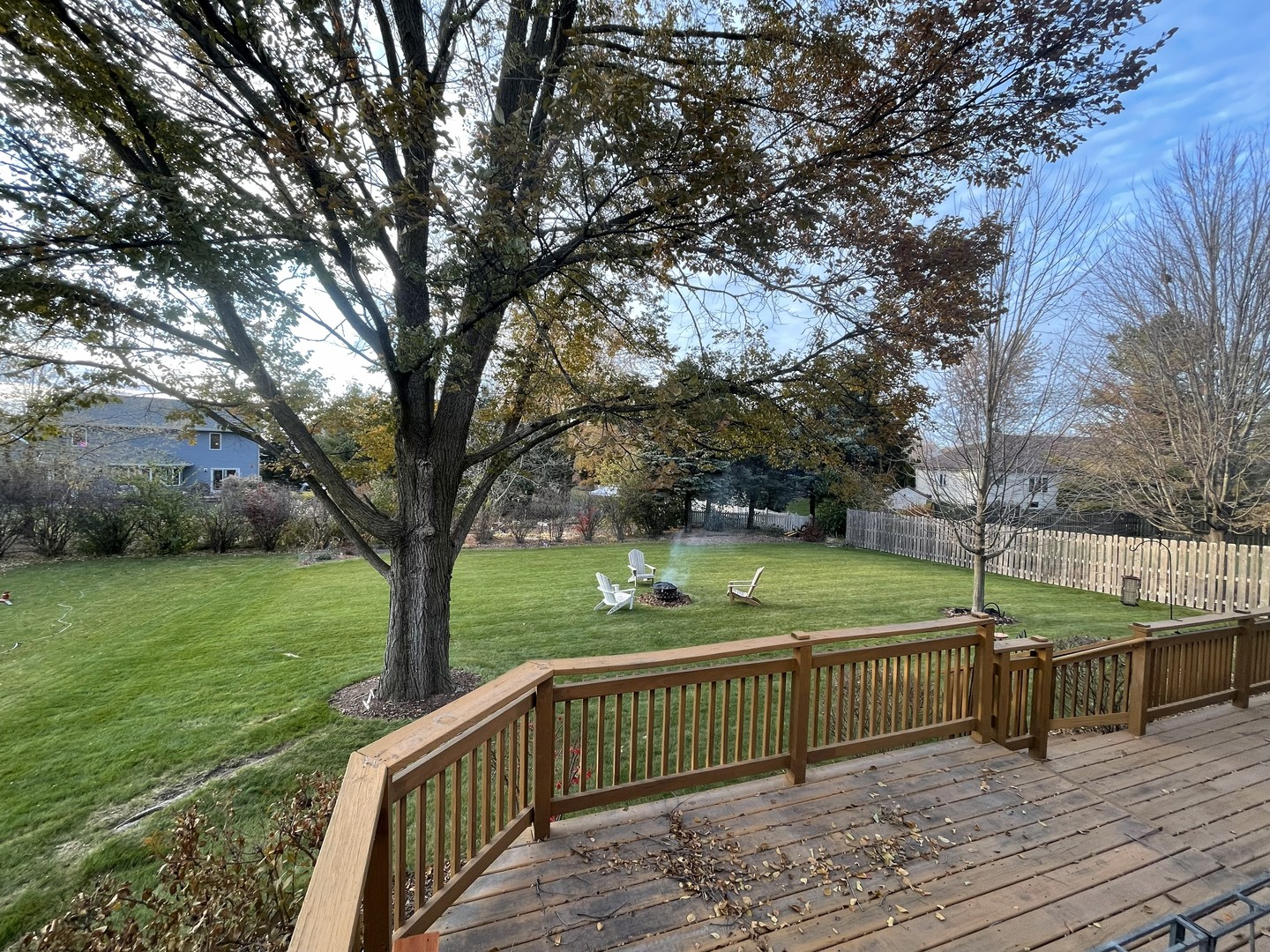 1205 South 1st Street DeKalb, IL 60115 - Photo 43 of 43 a view of a deck with large trees and wooden fence