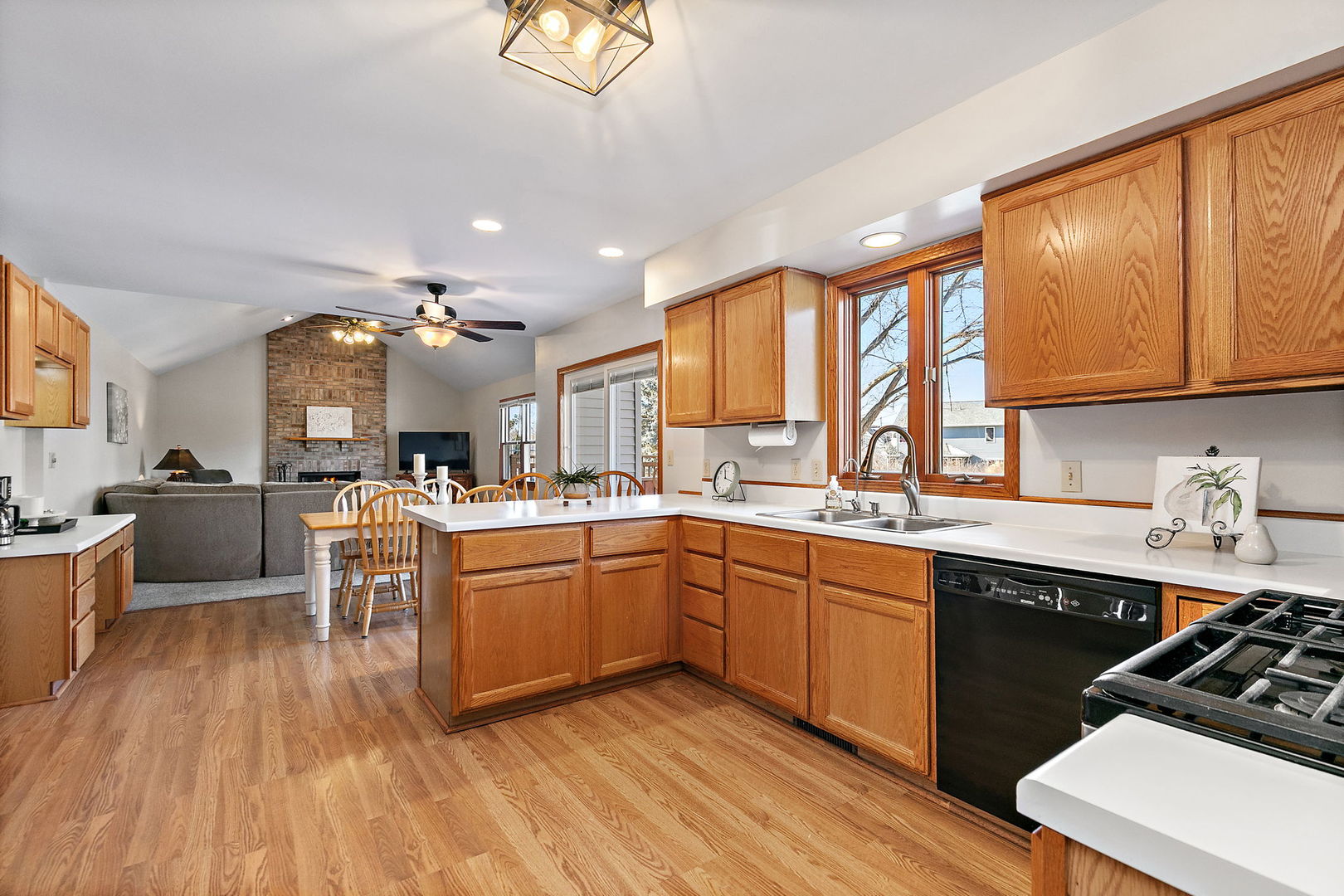 1205 South 1st Street DeKalb, IL 60115 - Photo 8 of 43 a open kitchen with kitchen island granite countertop a sink cabinets and wooden floor