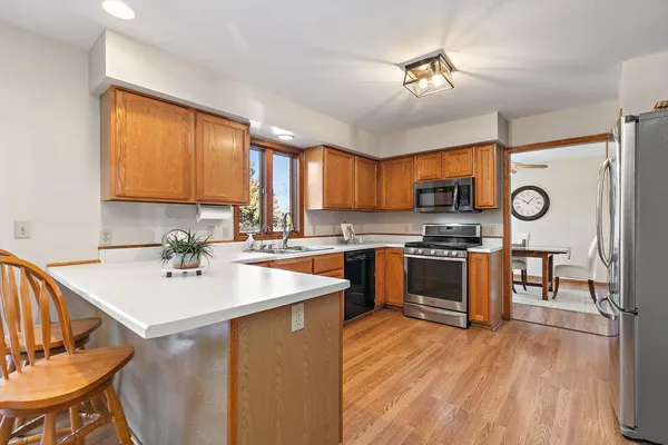 a kitchen with a sink appliances and cabinets