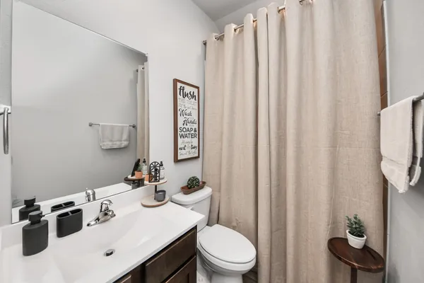 a kitchen with stainless steel appliances kitchen island granite countertop a table chairs and a refrigerator