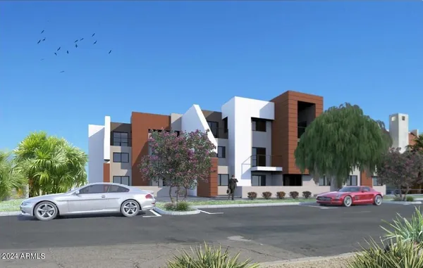 front view of a house with a garden and parking