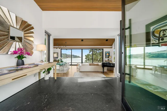 a living room with fireplace furniture and a large window