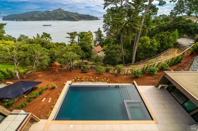 a kitchen with stainless steel appliances kitchen island granite countertop a stove a sink and a refrigerator