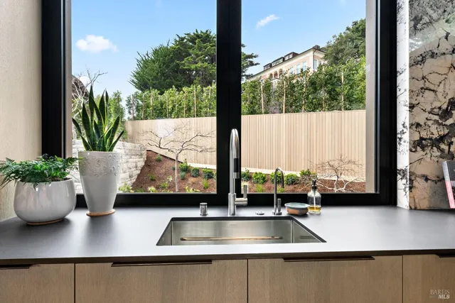 a spacious bedroom with a bed couch and a large window with outer view