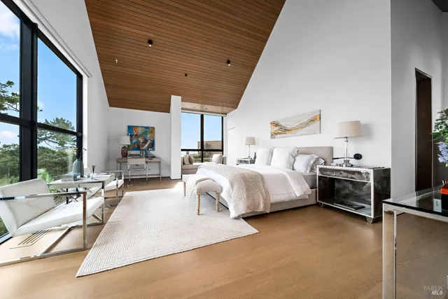 a bedroom with a large bed and a large window