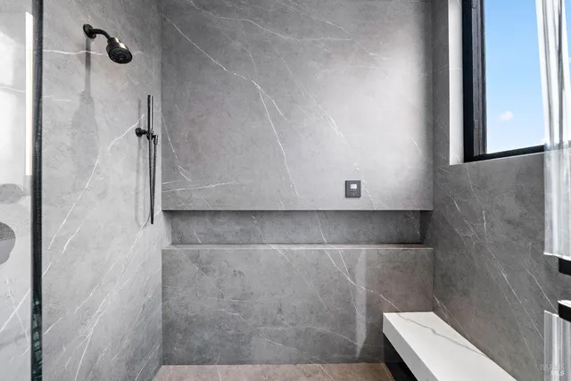 a living room with furniture and floor to ceiling window