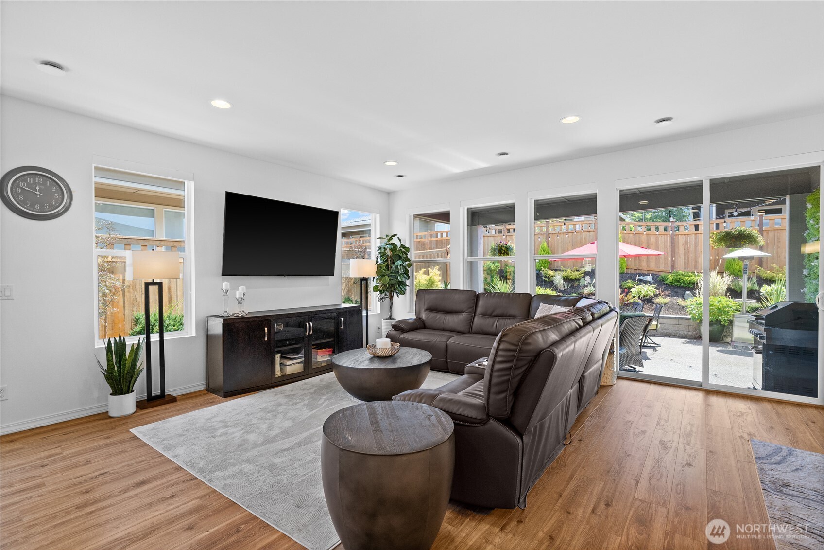 15215 182nd Avenue East Bonney Lake, WA 98391 - Photo 11 of 40 a living room with furniture flat screen tv and wooden floor
