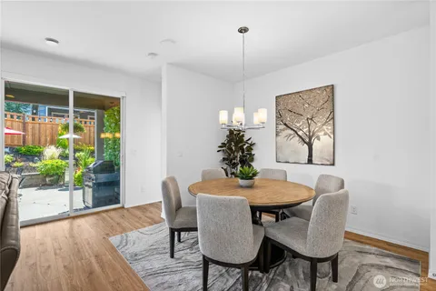 a view of a dining room with furniture window and wooden floor