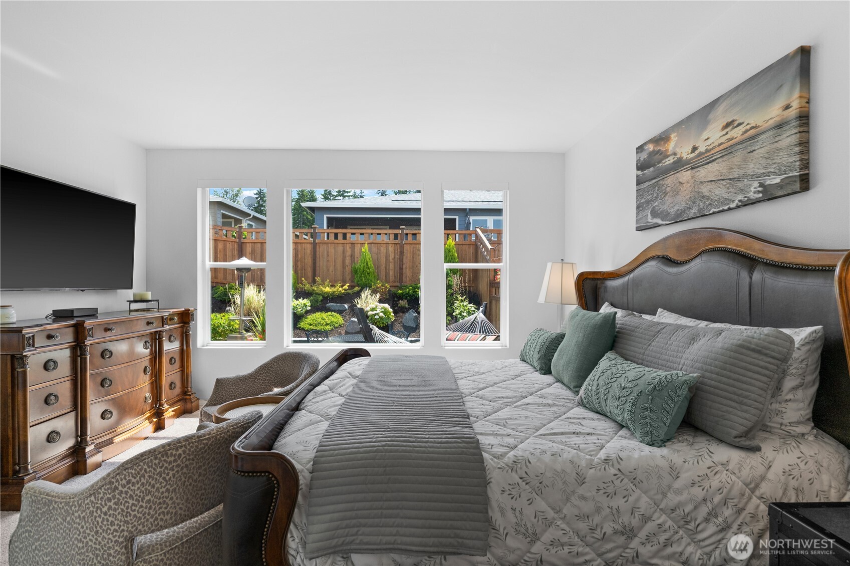 15215 182nd Avenue East Bonney Lake, WA 98391 - Photo 19 of 40 a spacious bedroom with a bed and a flat screen tv