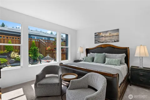 a bedroom with a bed and a large window