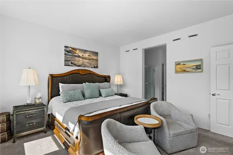 a bedroom with a bed and couch