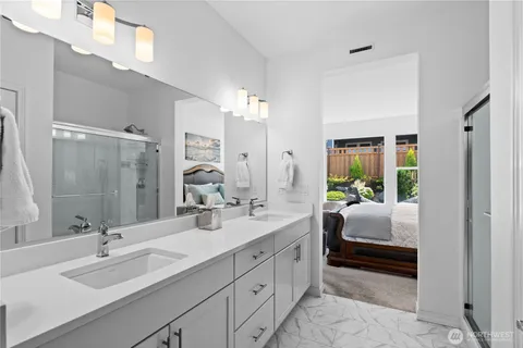 a bathroom with a double vanity sink mirror and double