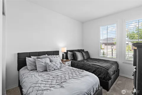 a bedroom with a bed and a large window