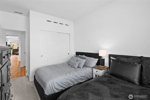 a bedroom with a bed and a television