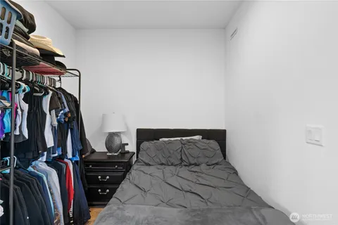 a bed with a black white bedspread and pillows