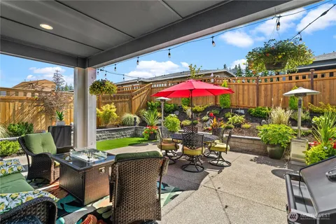 a view of a patio with chairs and potted plants