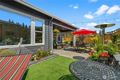 a view of a patio with a table and chairs under an umbrella