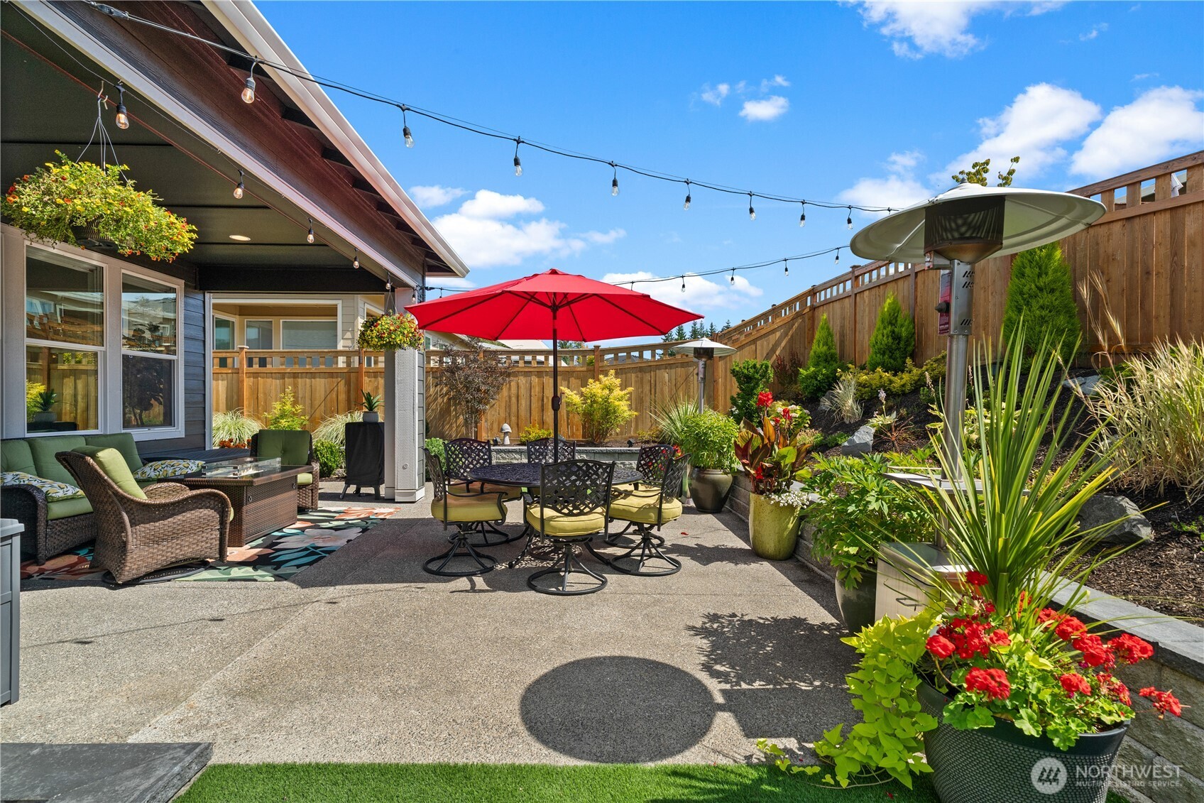 15215 182nd Avenue East Bonney Lake, WA 98391 - Photo 39 of 40 a view of a patio with a table and chairs under an umbrella