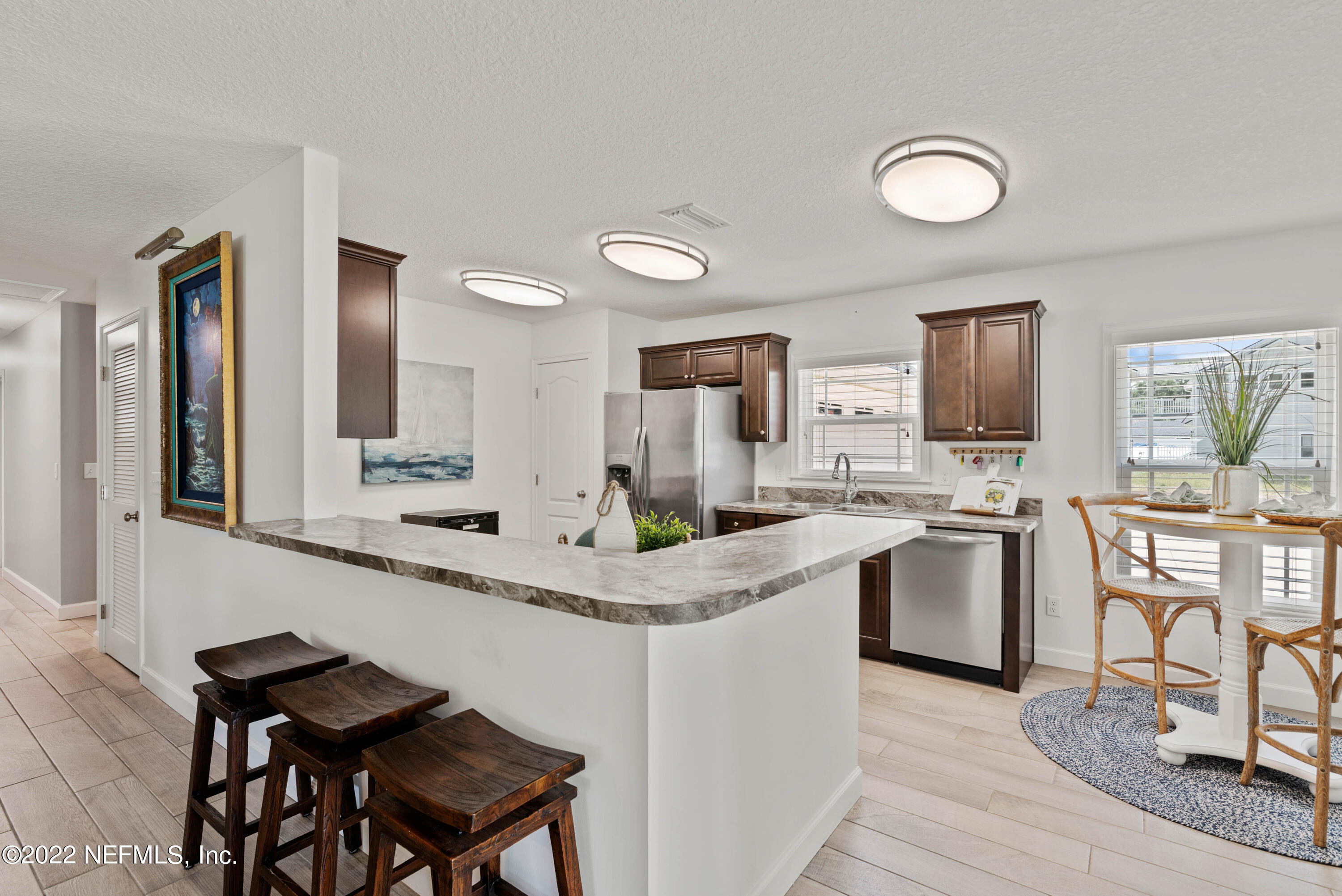 6434 Cabana Trace Starke, FL 32091 - Photo 11 of 38 a kitchen with stainless steel appliances kitchen island granite countertop a sink and cabinets