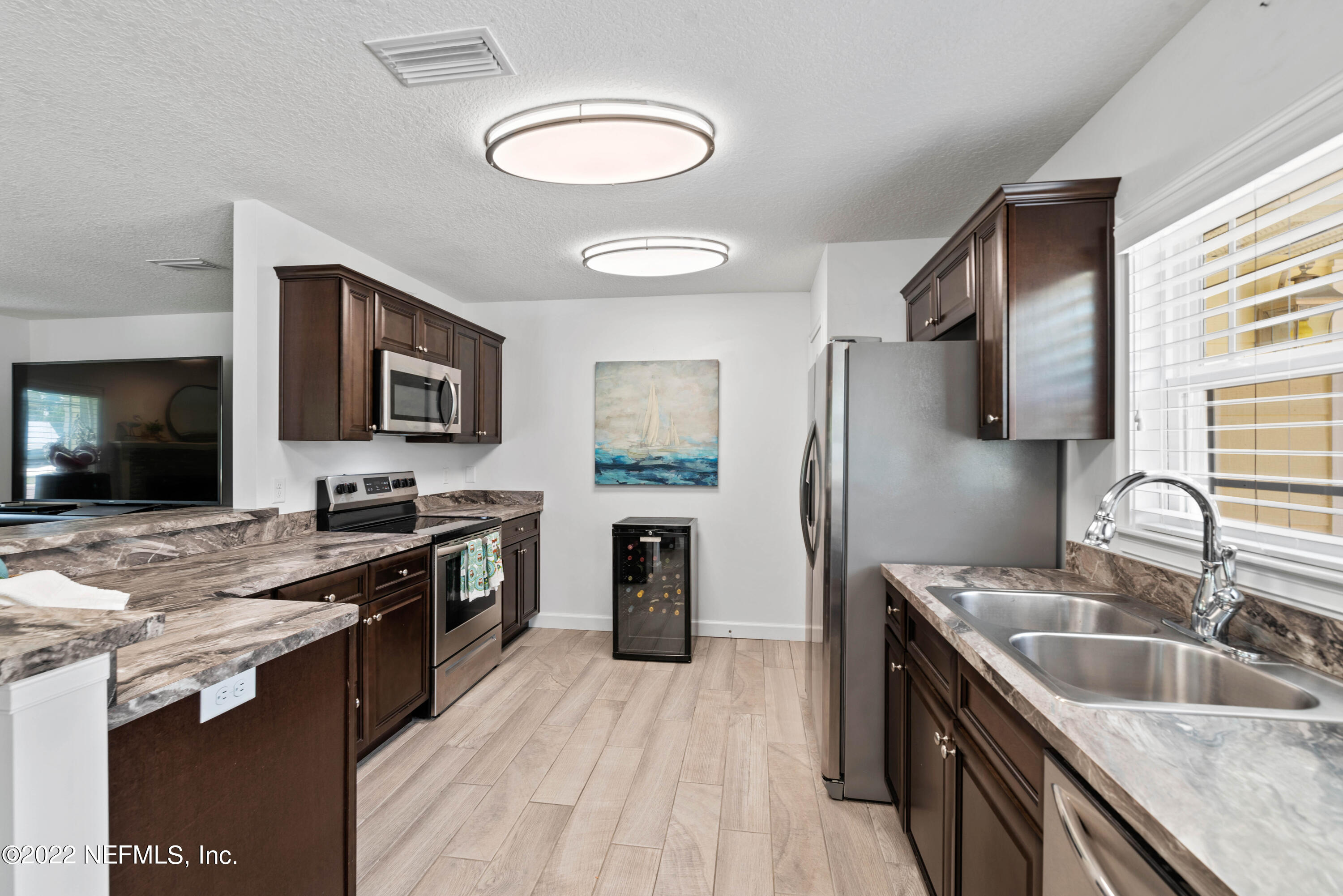 6434 Cabana Trace Starke, FL 32091 - Photo 12 of 38 a kitchen with stainless steel appliances granite countertop a sink stove and refrigerator