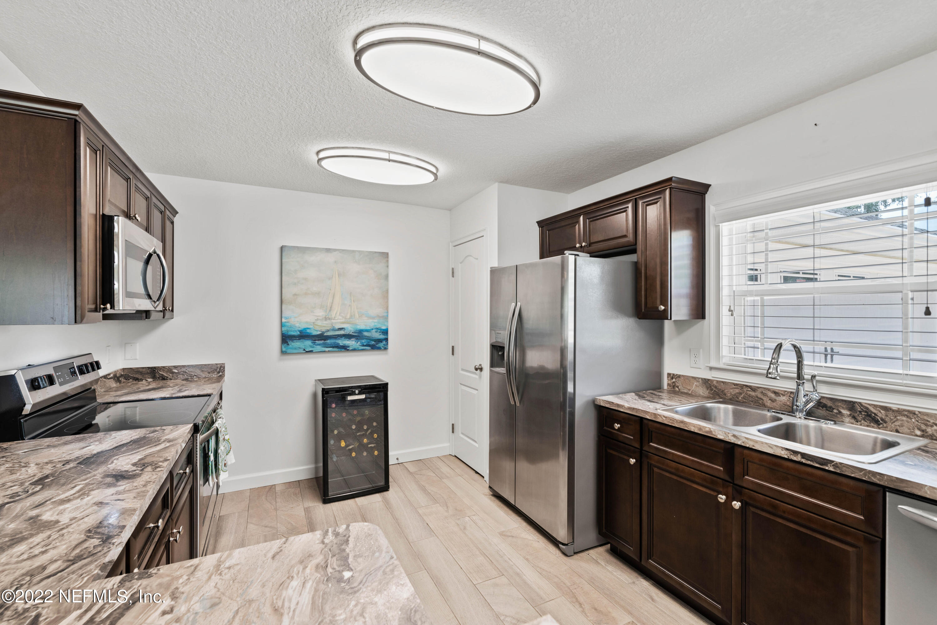 6434 Cabana Trace Starke, FL 32091 - Photo 14 of 38 a kitchen with stainless steel appliances granite countertop a sink stove and refrigerator