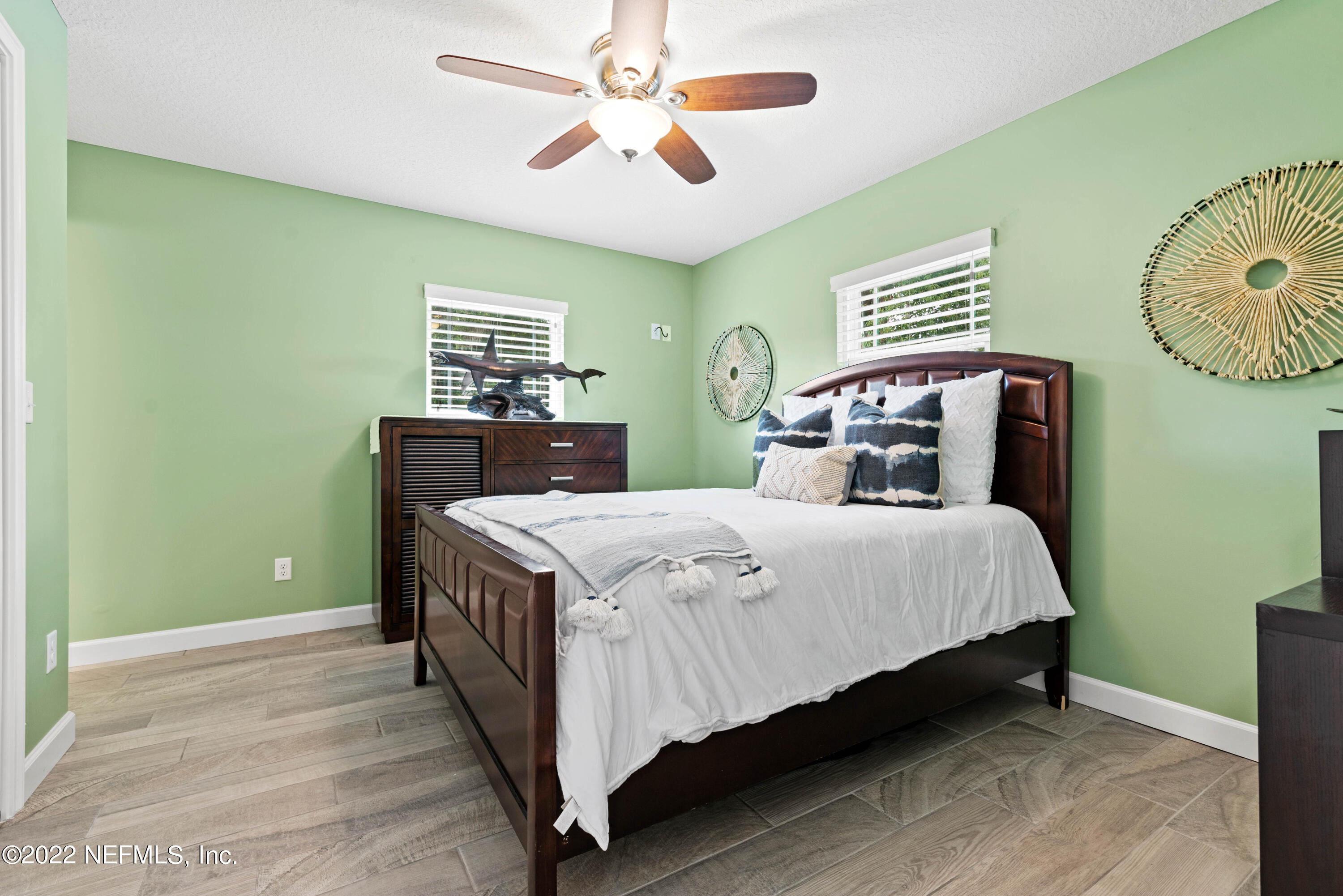 6434 Cabana Trace Starke, FL 32091 - Photo 16 of 38 a bedroom with a bed and a chandelier