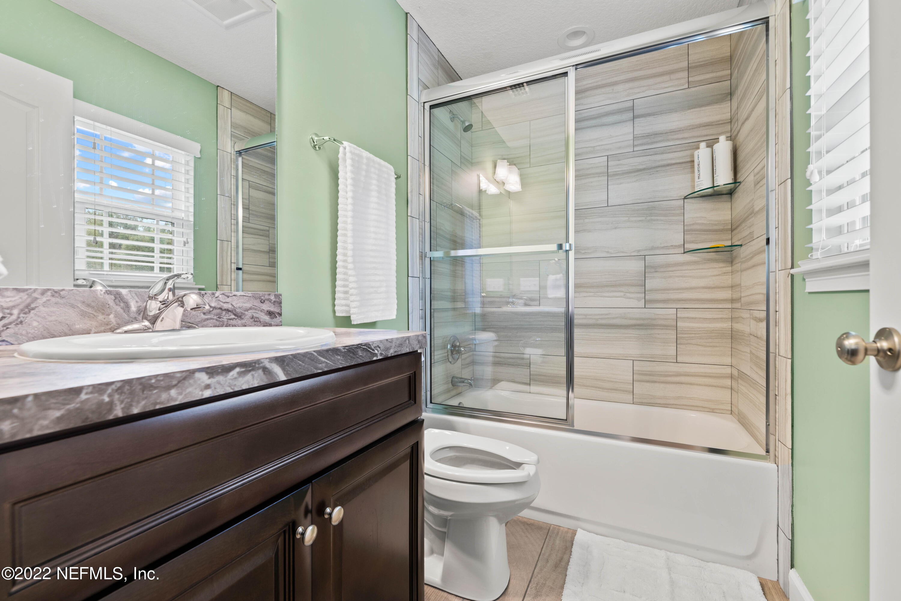 6434 Cabana Trace Starke, FL 32091 - Photo 17 of 38 a bathroom with a granite countertop sink toilet and shower