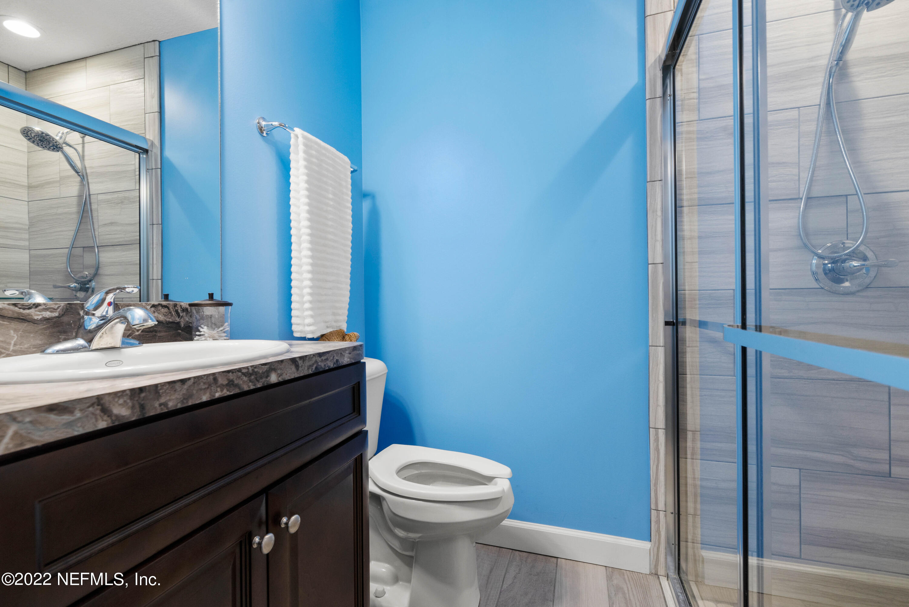 6434 Cabana Trace Starke, FL 32091 - Photo 19 of 38 a bathroom with a granite countertop sink toilet and mirror