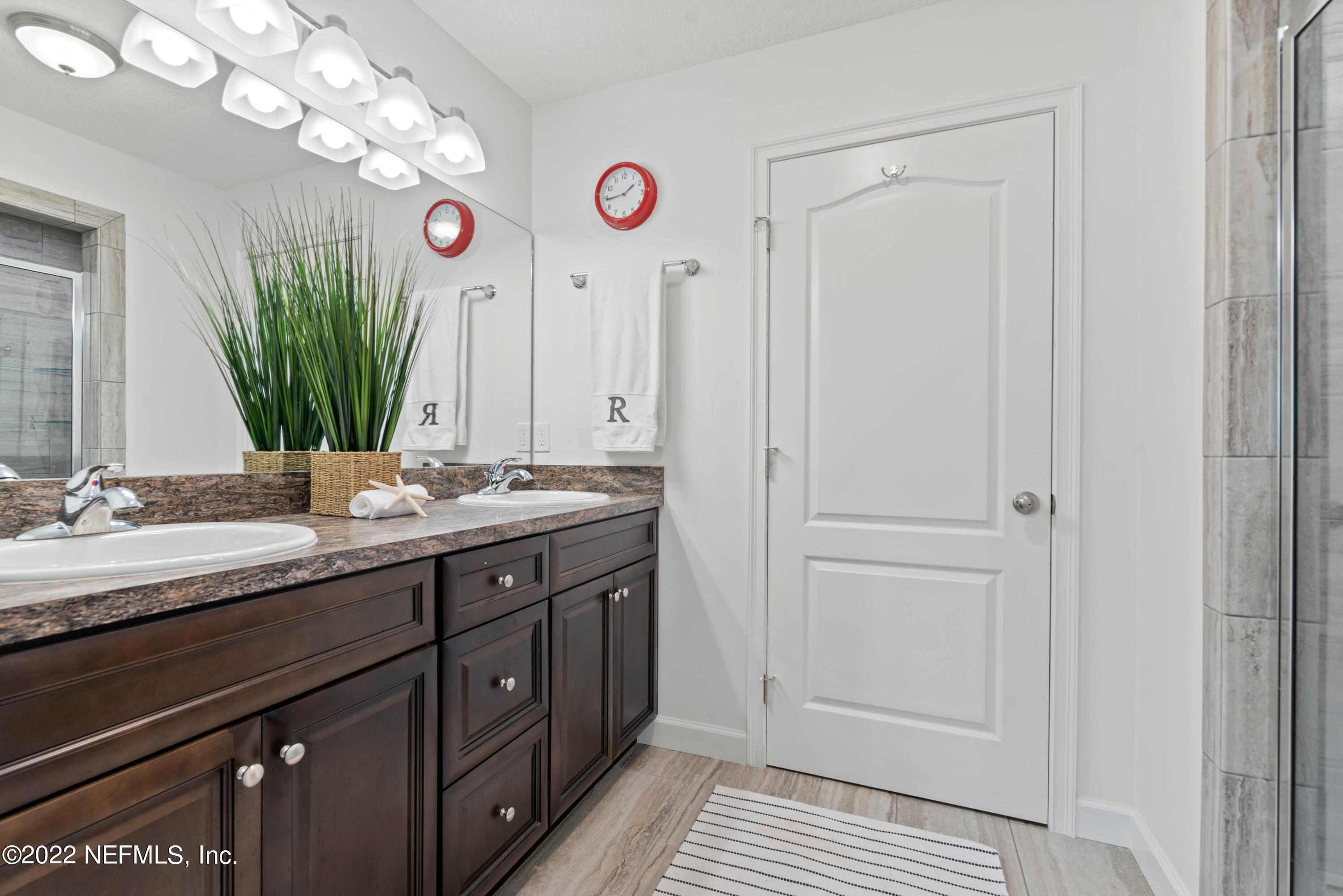 6434 Cabana Trace Starke, FL 32091 - Photo 22 of 38 a bathroom with a double vanity sink and a mirror