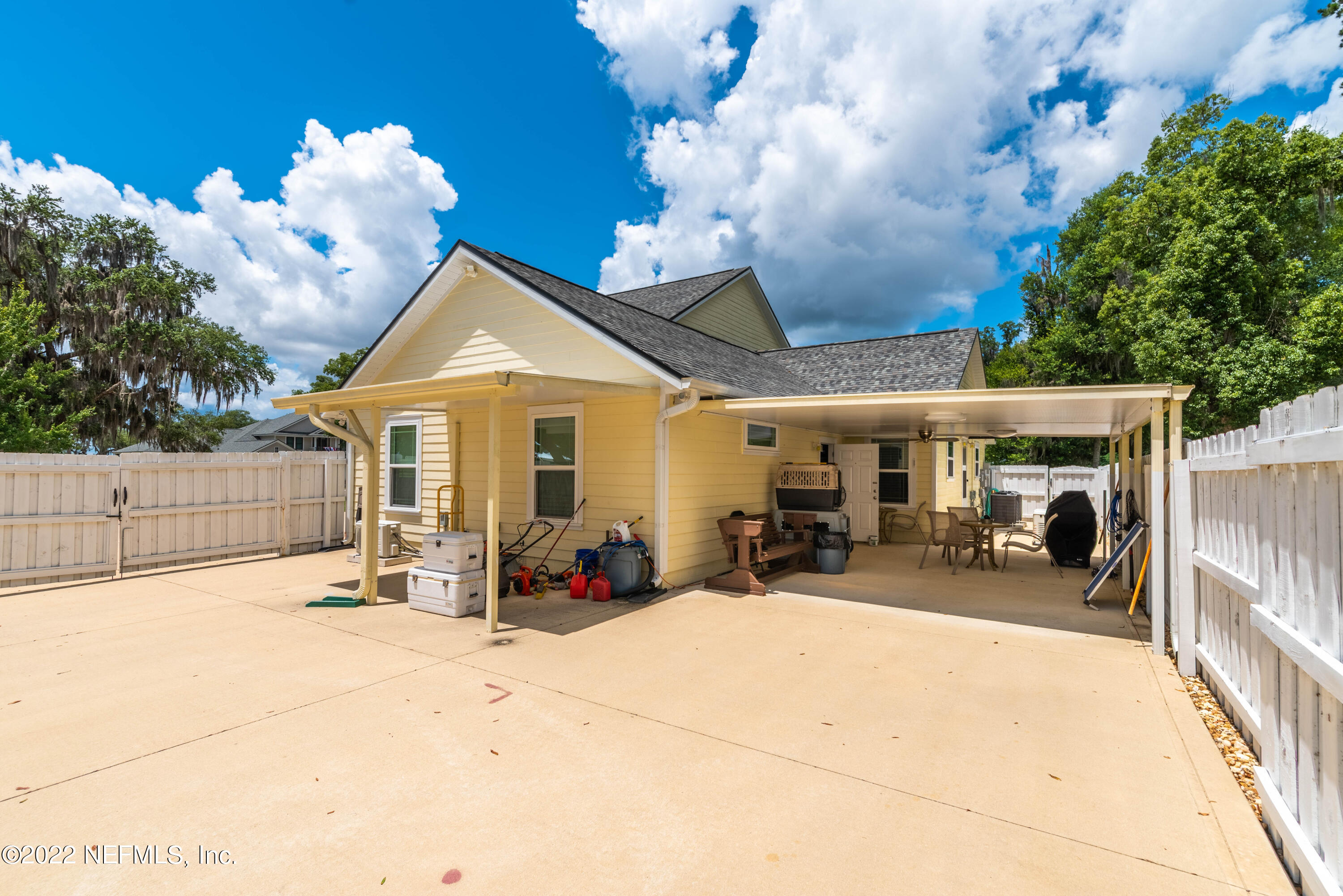 6434 Cabana Trace Starke, FL 32091 - Photo 25 of 38 a view of a patio with table and chairs and potted plants