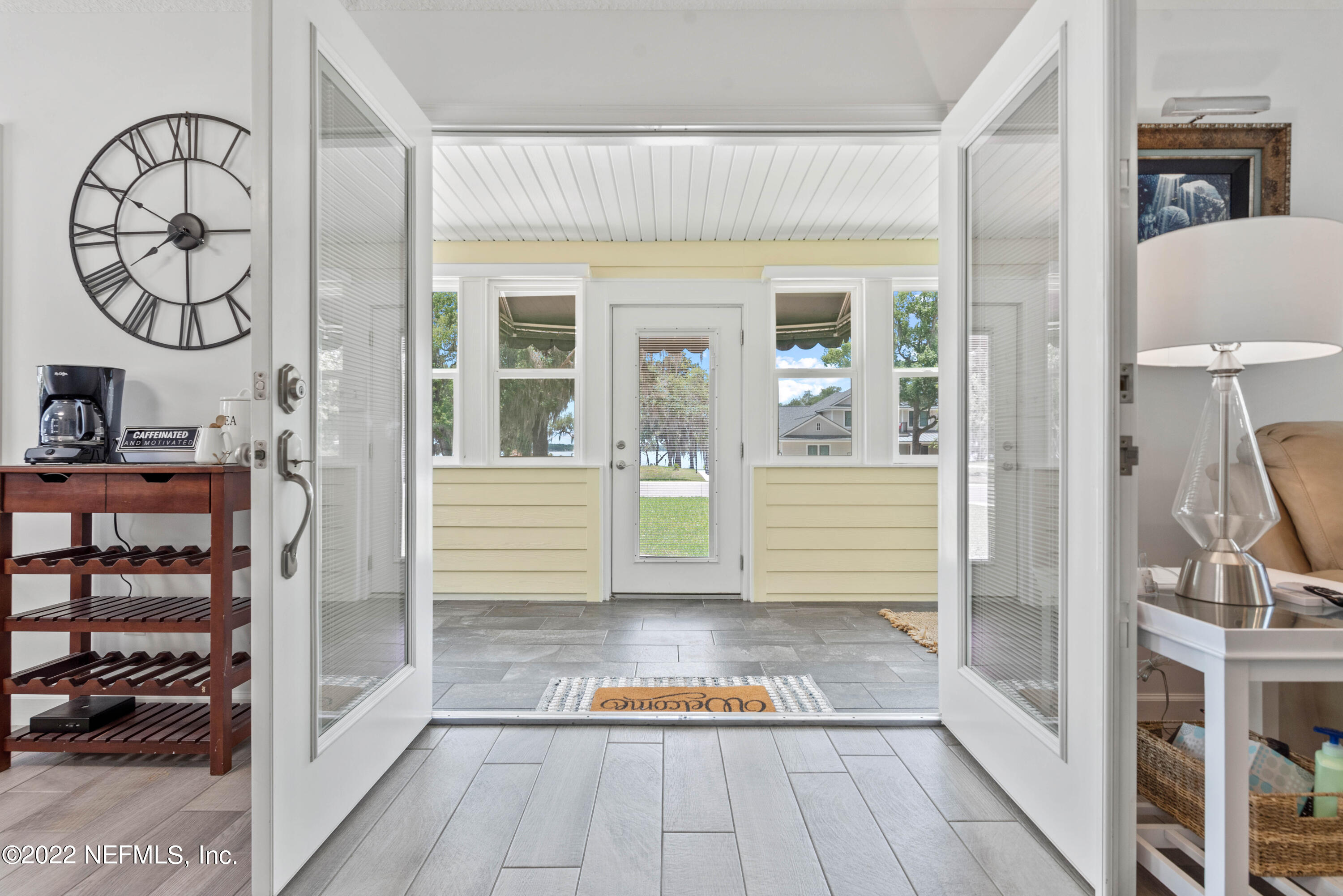 6434 Cabana Trace Starke, FL 32091 - Photo 5 of 38 a view of a hallway with wooden floor and a living room