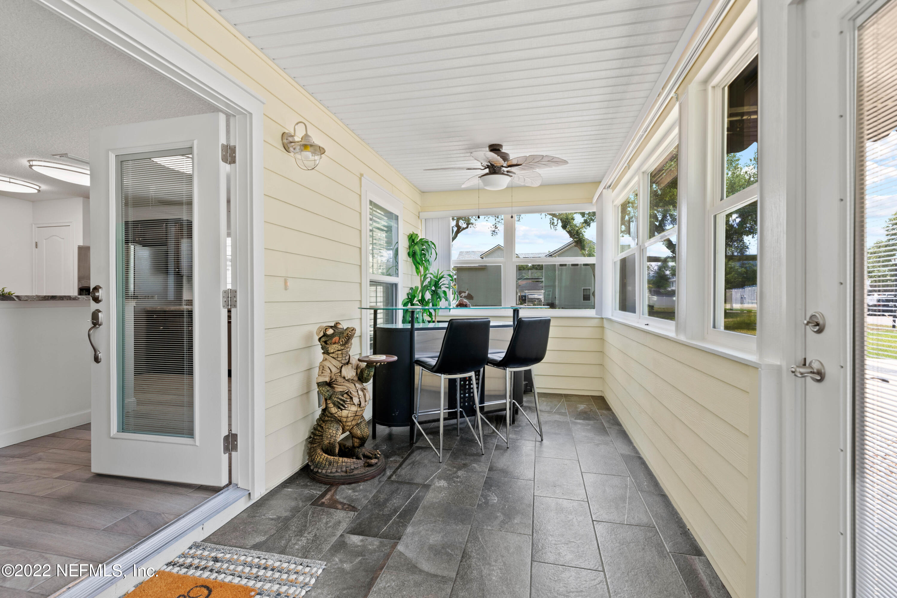 6434 Cabana Trace Starke, FL 32091 - Photo 6 of 38 a view of a patio with table and chairs and floor to ceiling window