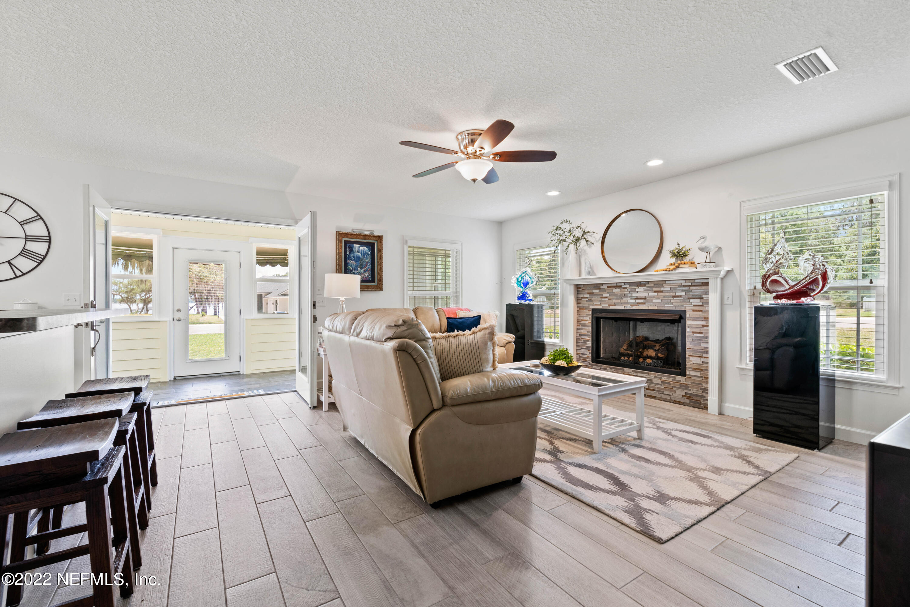6434 Cabana Trace Starke, FL 32091 - Photo 8 of 38 a living room with furniture a fireplace and a ceiling fan