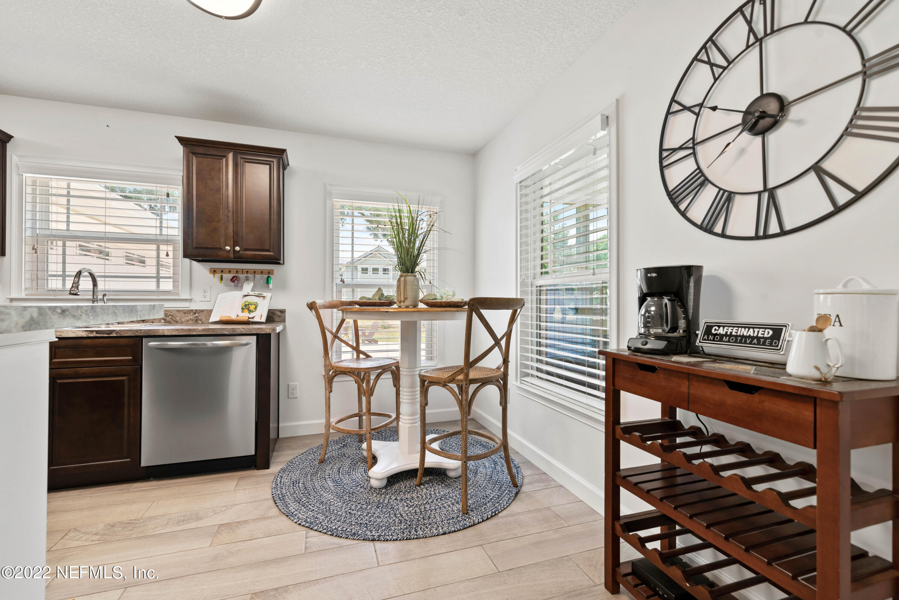 6434 Cabana Trace Starke, FL 32091 - Photo 10 of 38 a kitchen with a table chairs a stove a window and cabinets